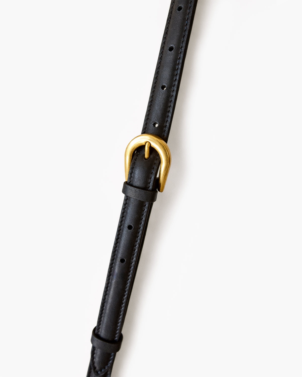 Black leather belt with a gold buckle on a white background
