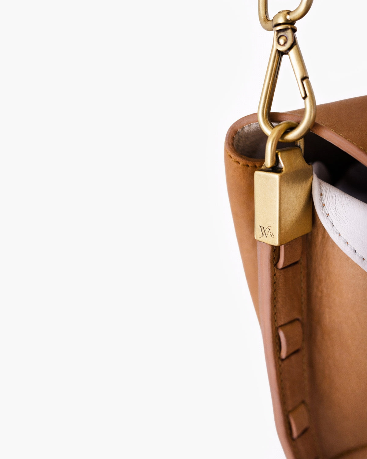 Close-up of a brown leather bag with a gold clasp on a white background