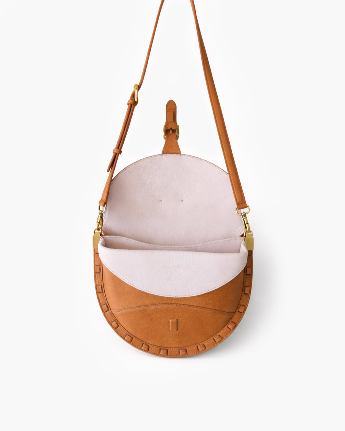 Brown leather handbag with a white interior on a light gray background