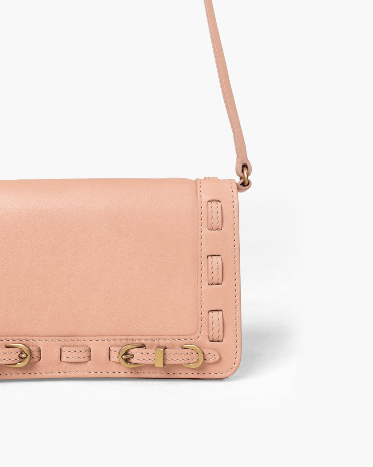 Pink handbag with brass accents on a white background