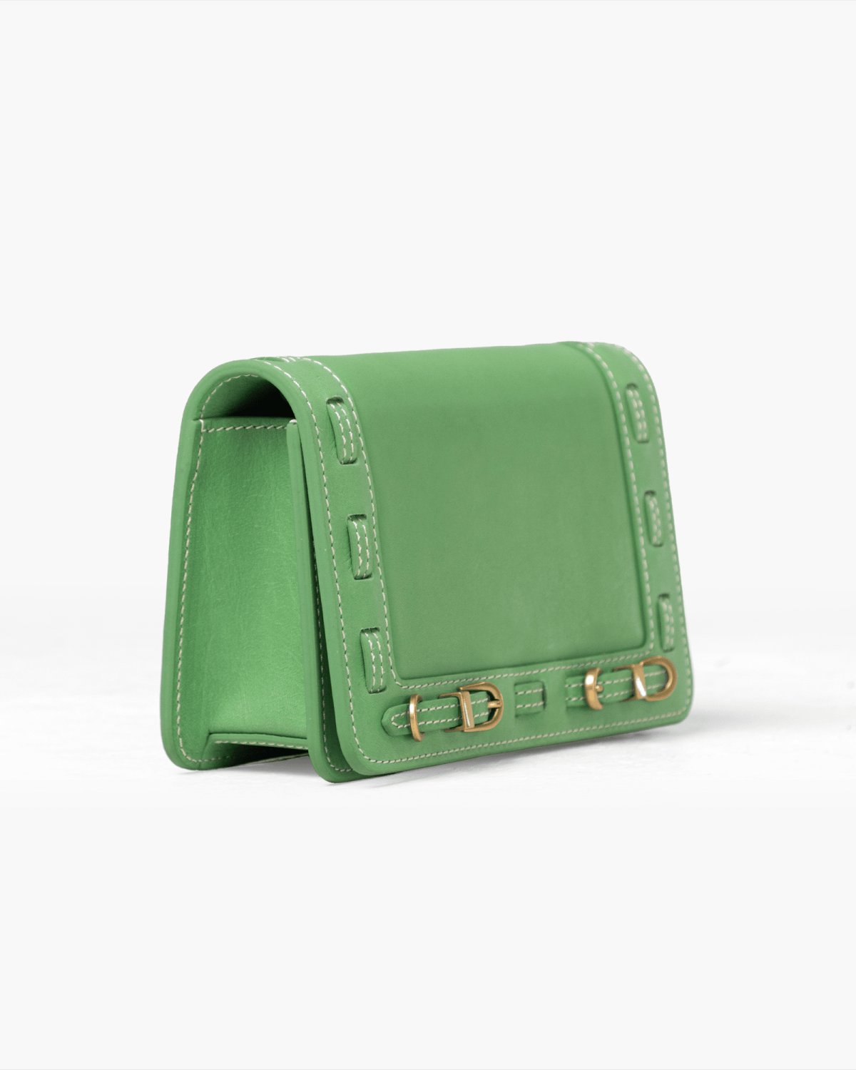Green handbag with brass accents on a white background