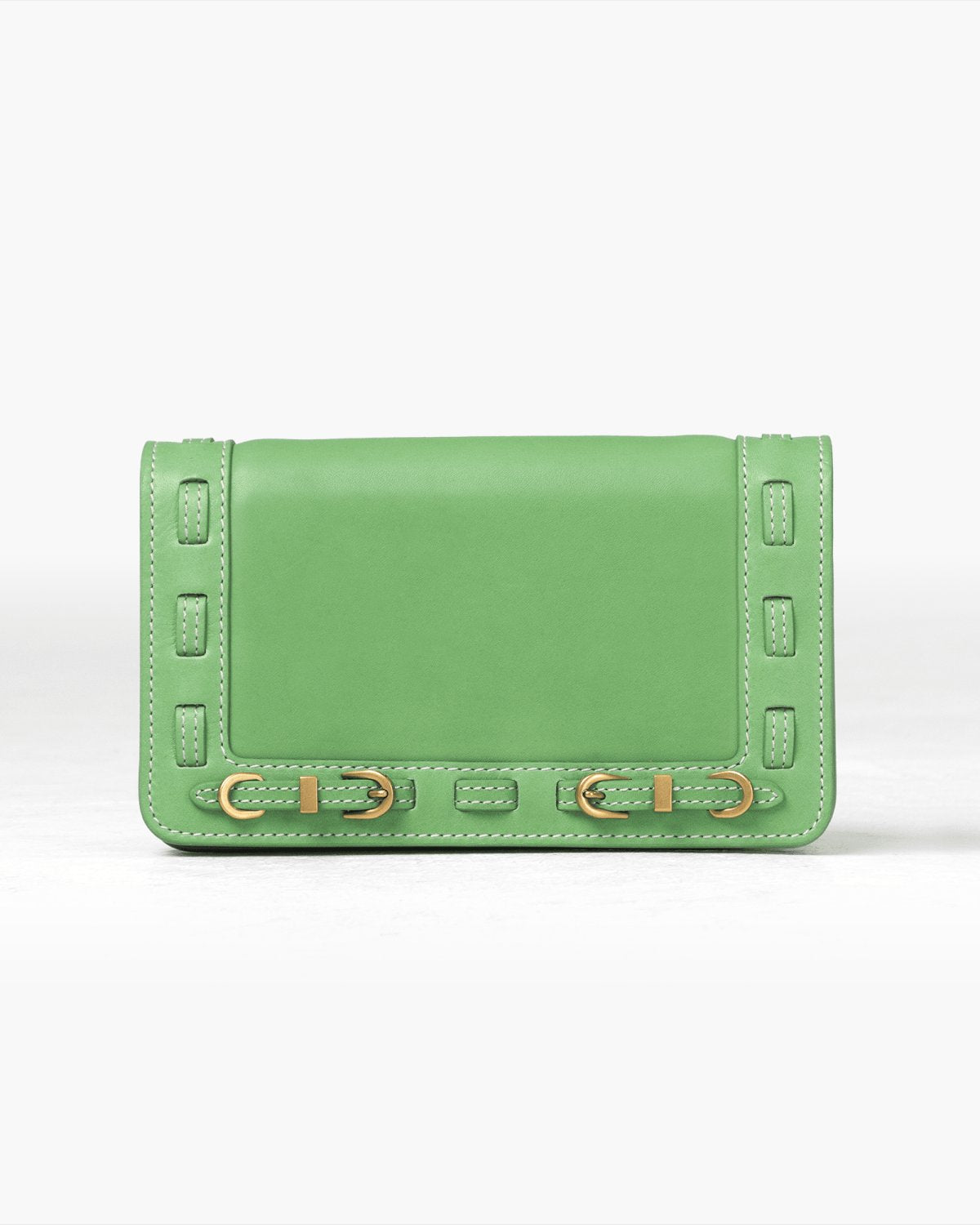 Green handbag with brass accents on a white background