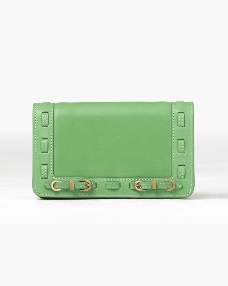 Green handbag with brass accents on a white background