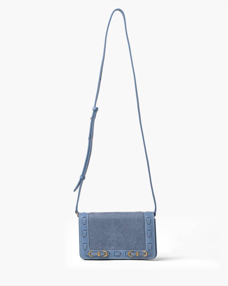 Blue handbag with brass accents on a white background