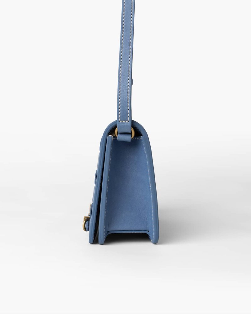 Blue handbag with a strap on a white background