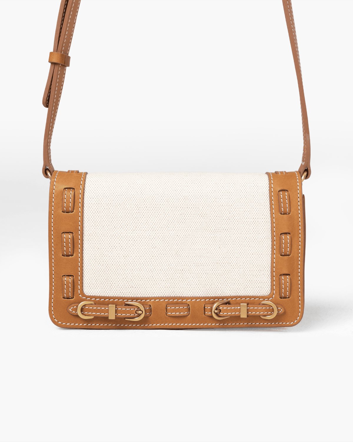 Handbag with light linen panel, brown leather accents on a white background