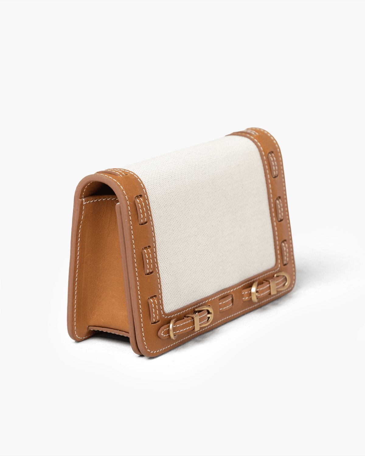 Handbag with light linen panel and brown leather accents on a white background