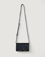 Black handbag with gold accents on a light gray background