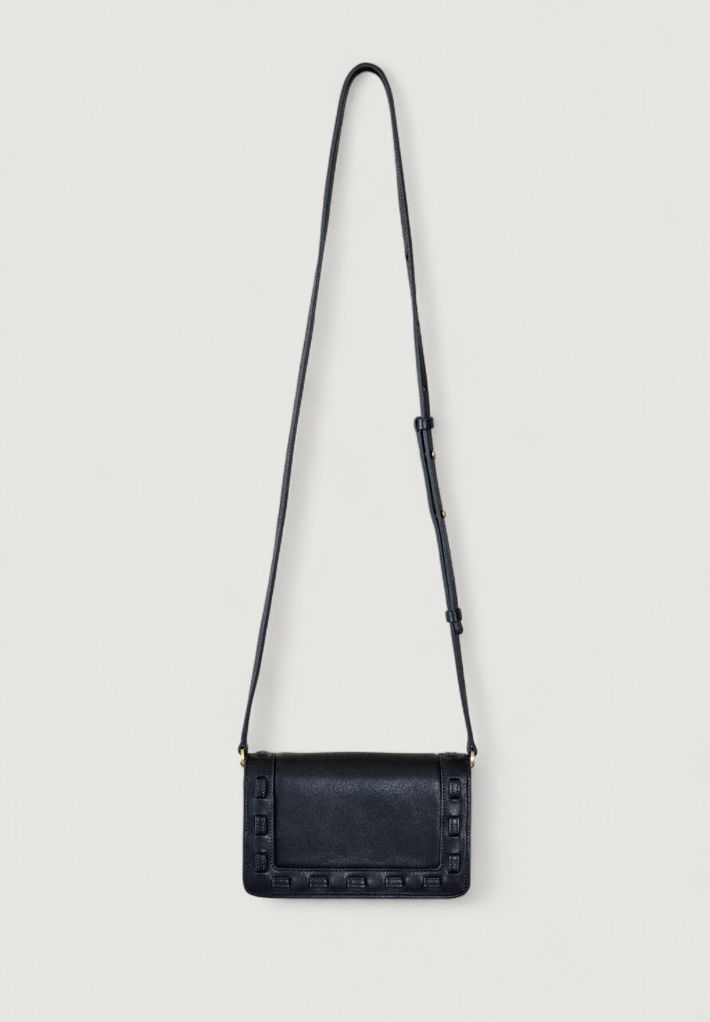Black leather crossbody bag on a light gray background