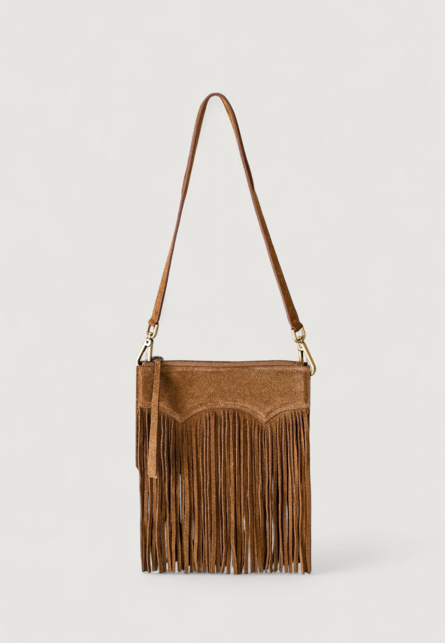 Brown suede handbag with fringe on a light gray background