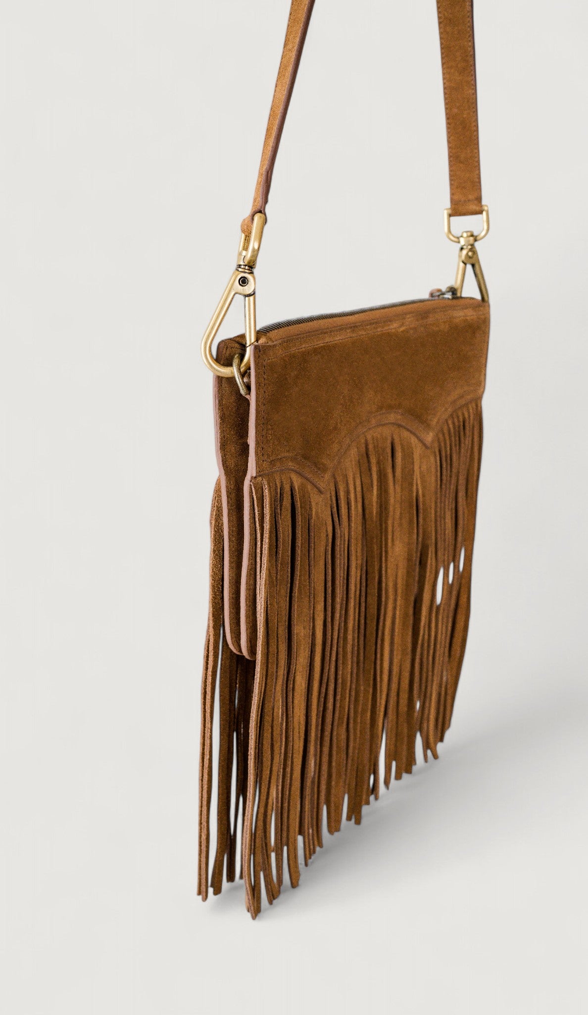 Brown suede handbag with fringe details on a light gray background