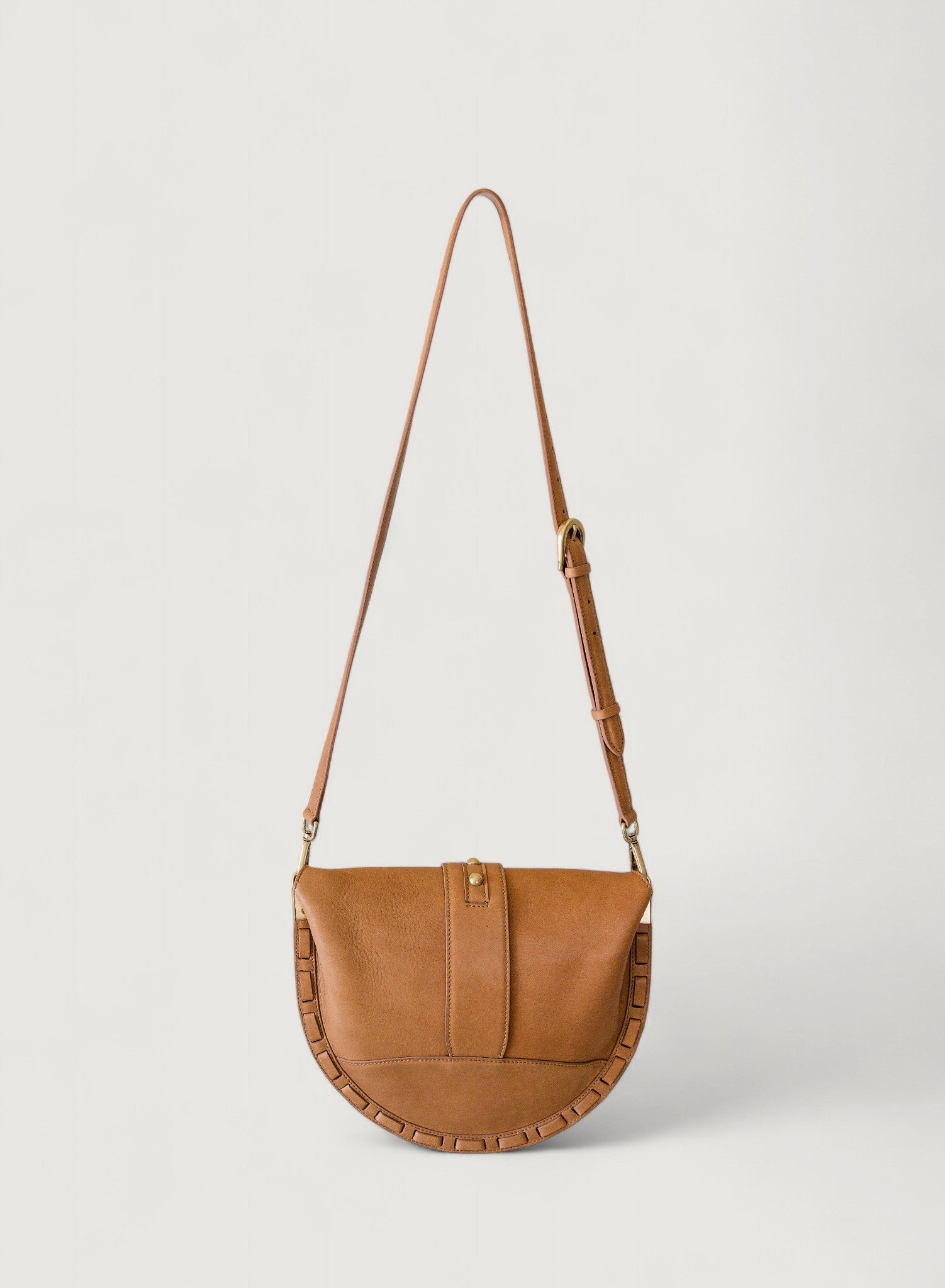 Brown leather handbag with a strap on a light gray background