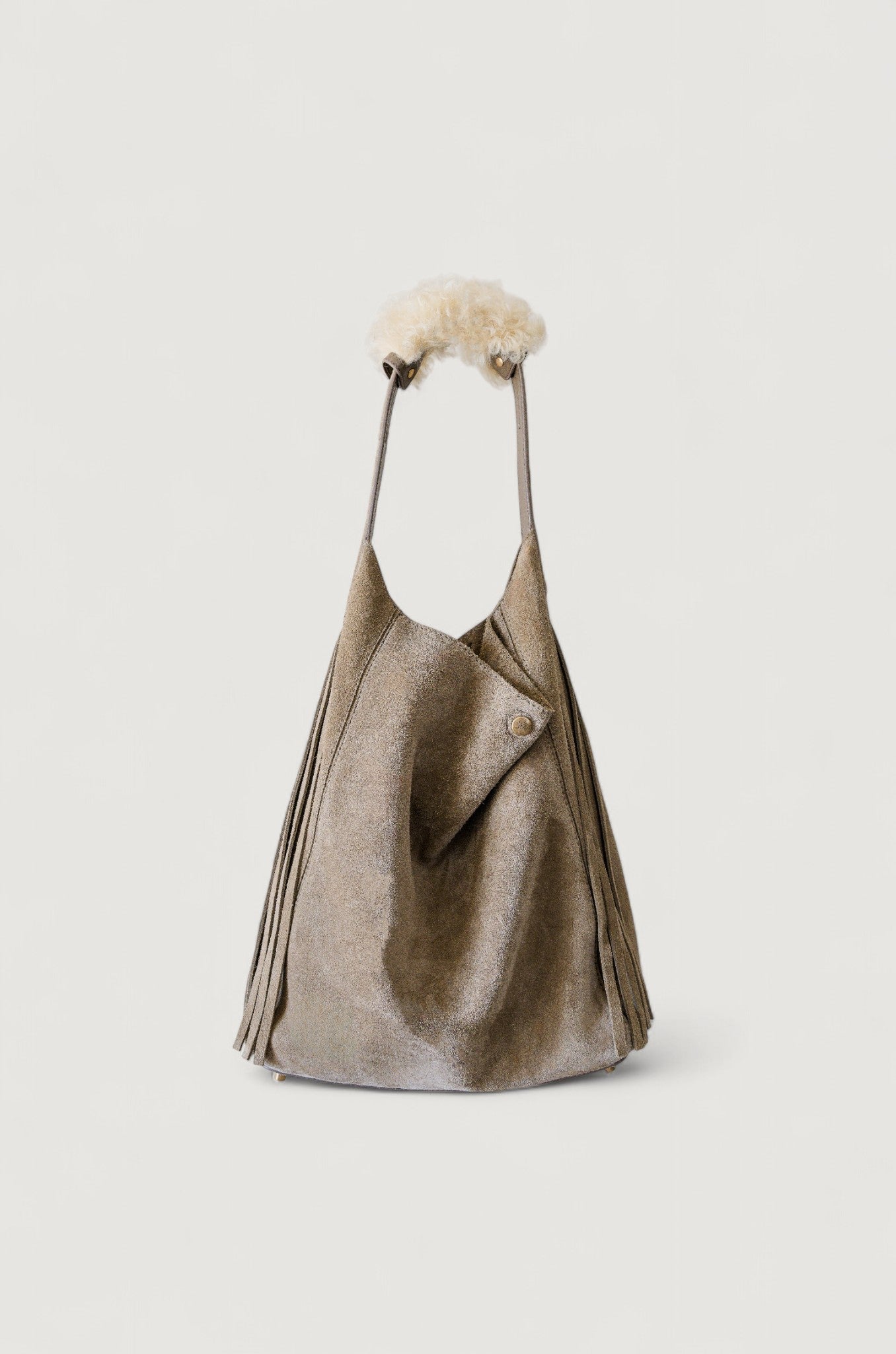 Gray leather handbag with shearling handle on a white background