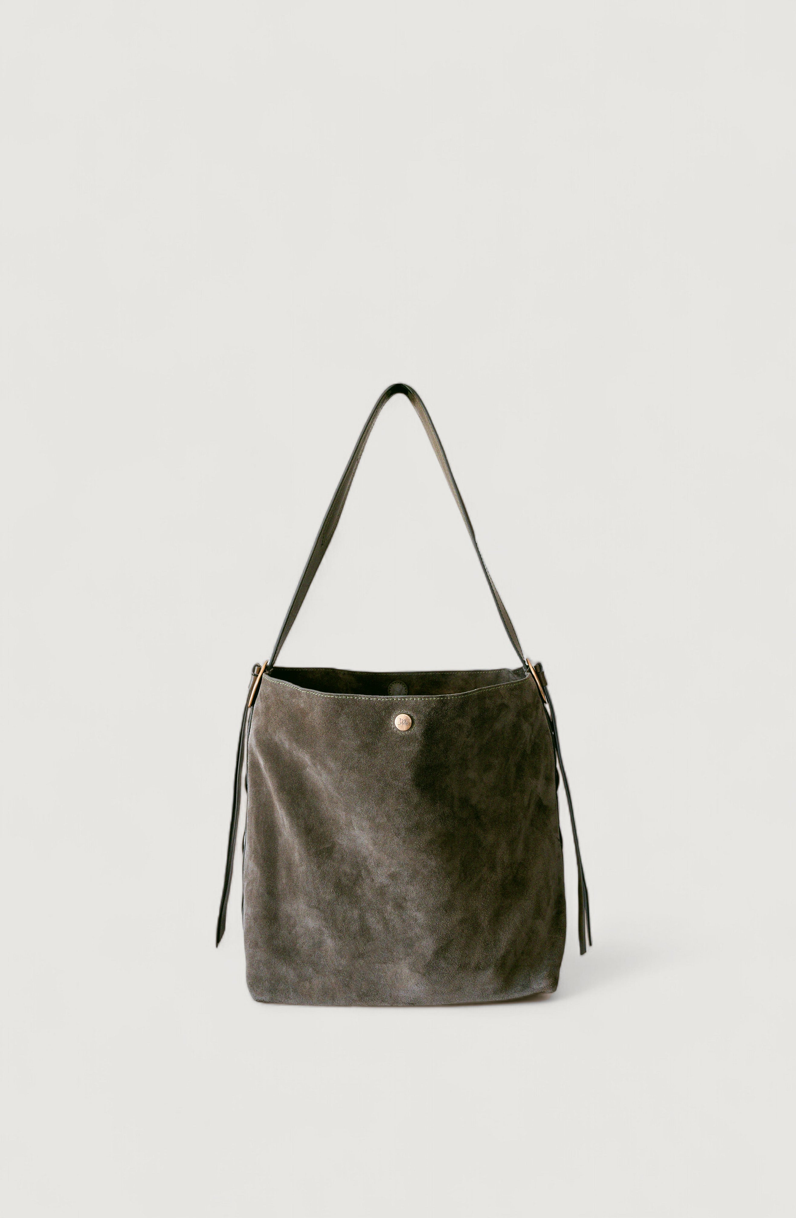 Olive leather handbag with a strap on a light gray background