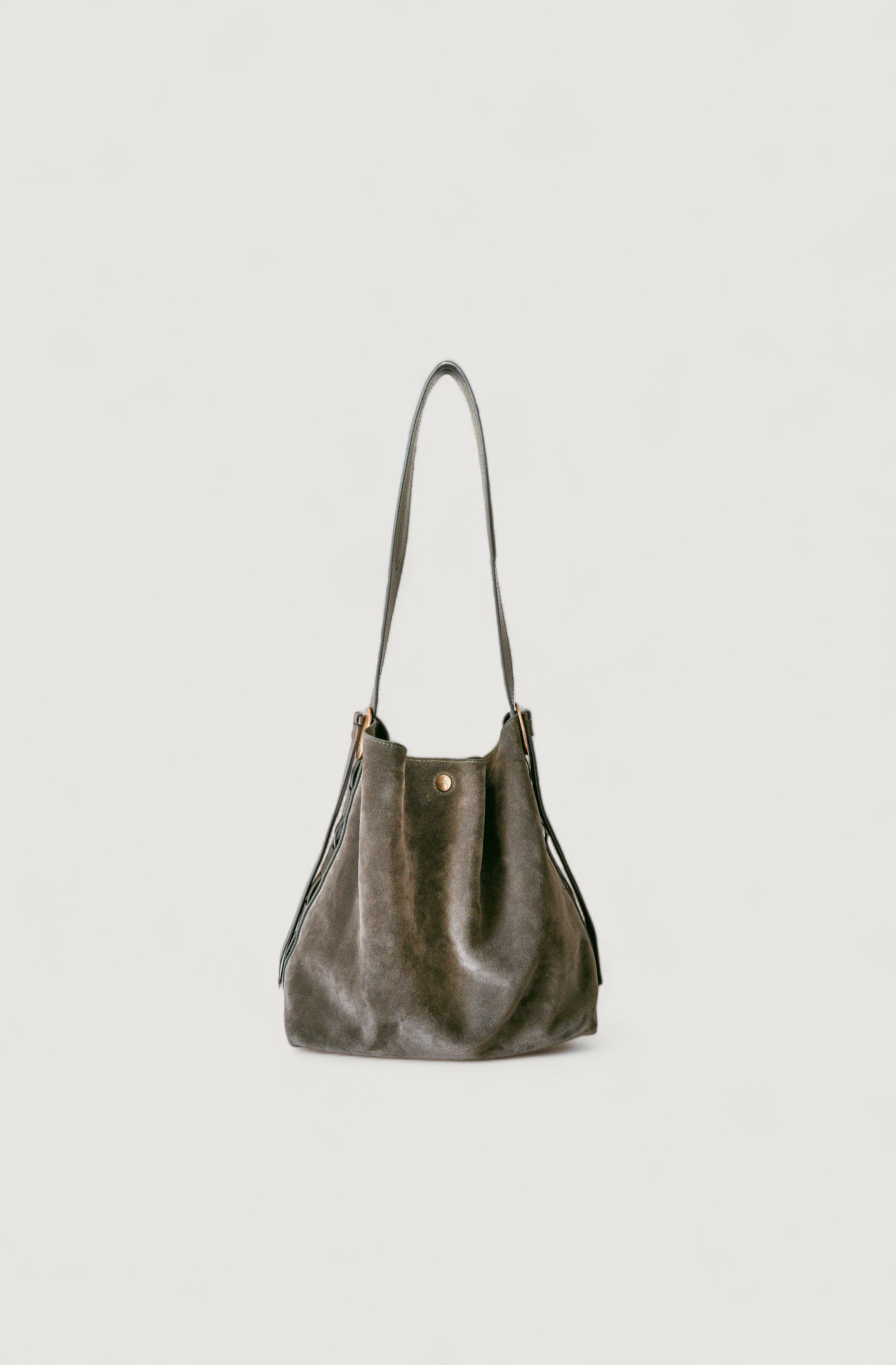 Olive leather handbag on a light gray background