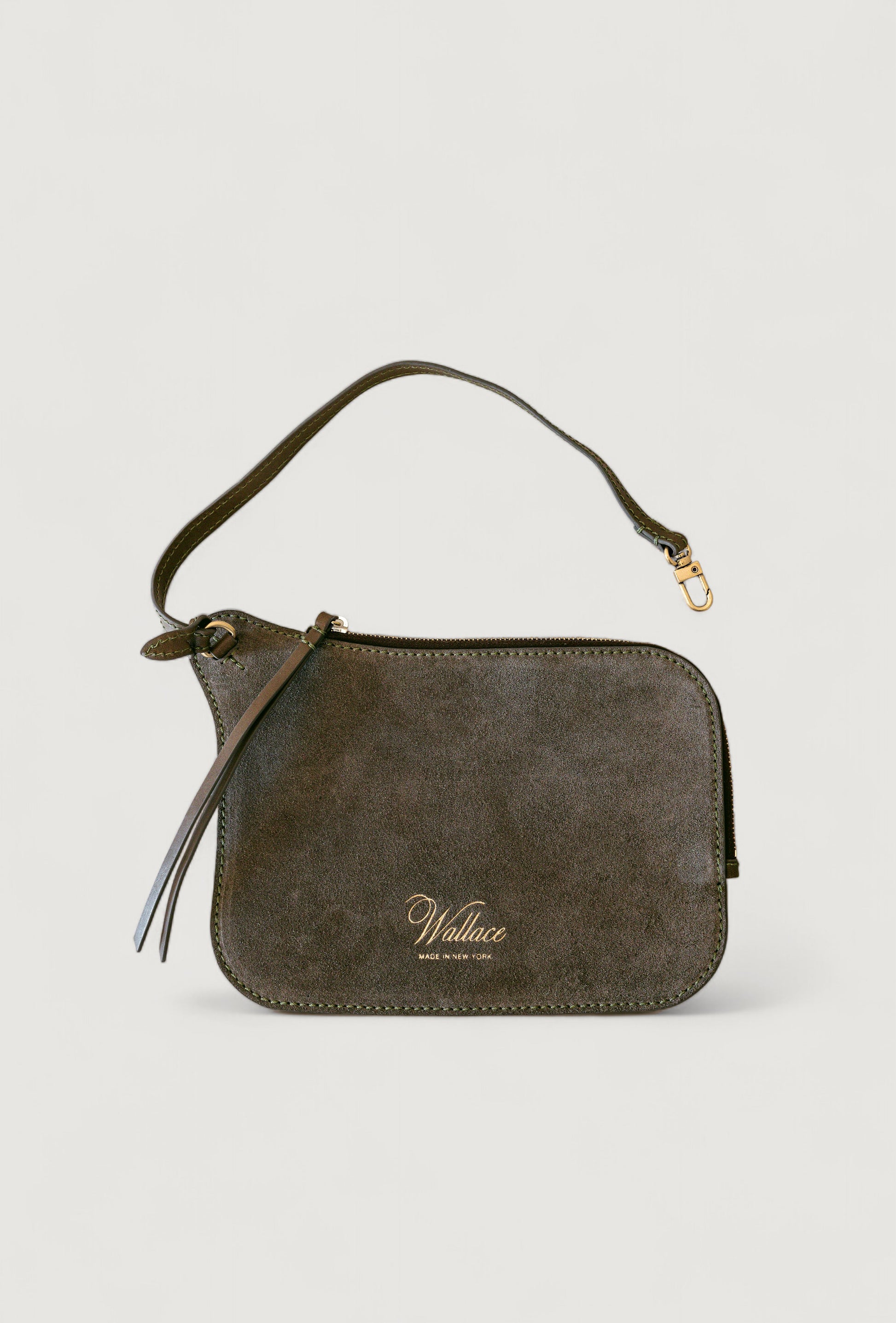 Olive suede handbag with a visible brand logo on a light gray background