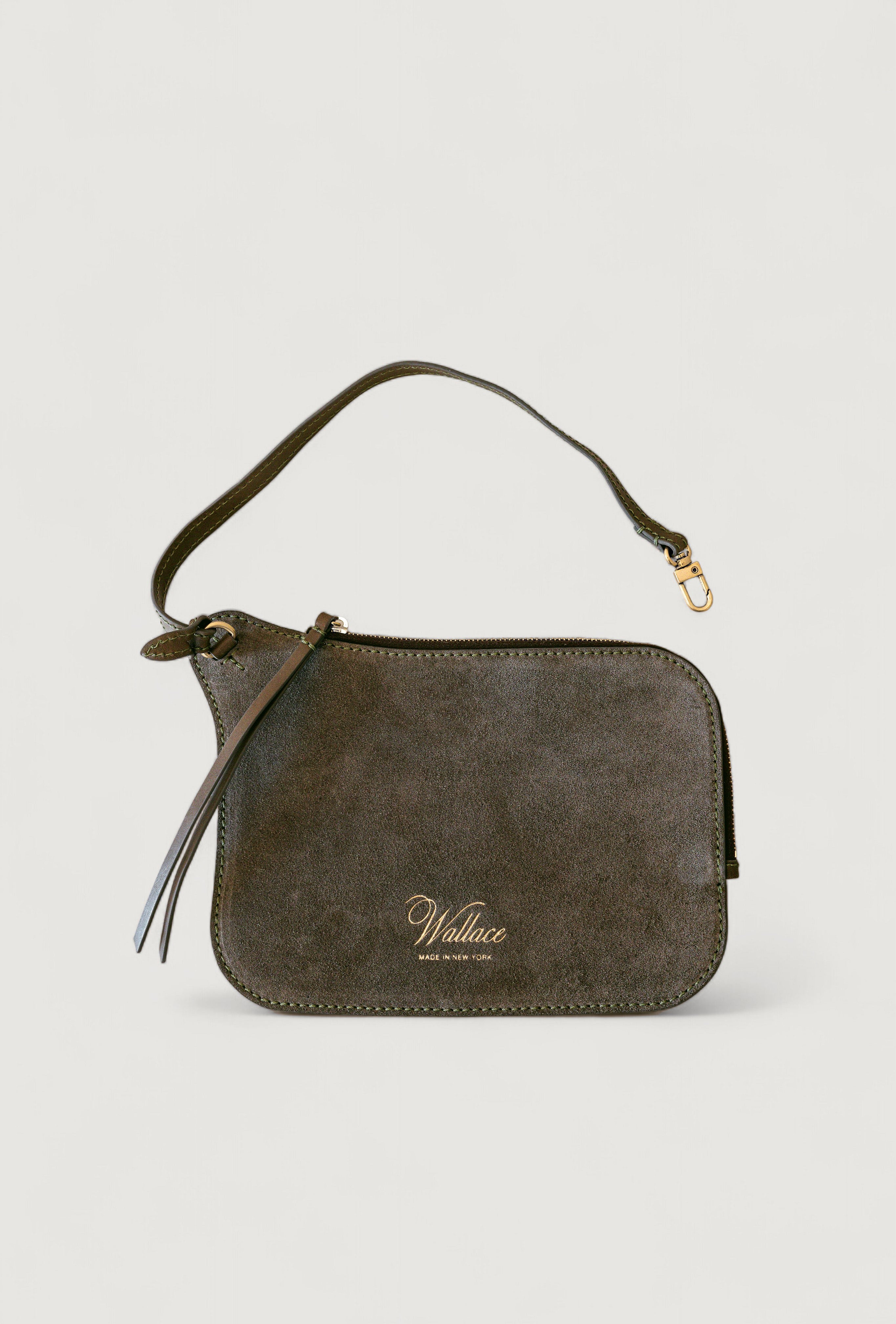 Olive suede handbag with a visible brand logo on a light gray background