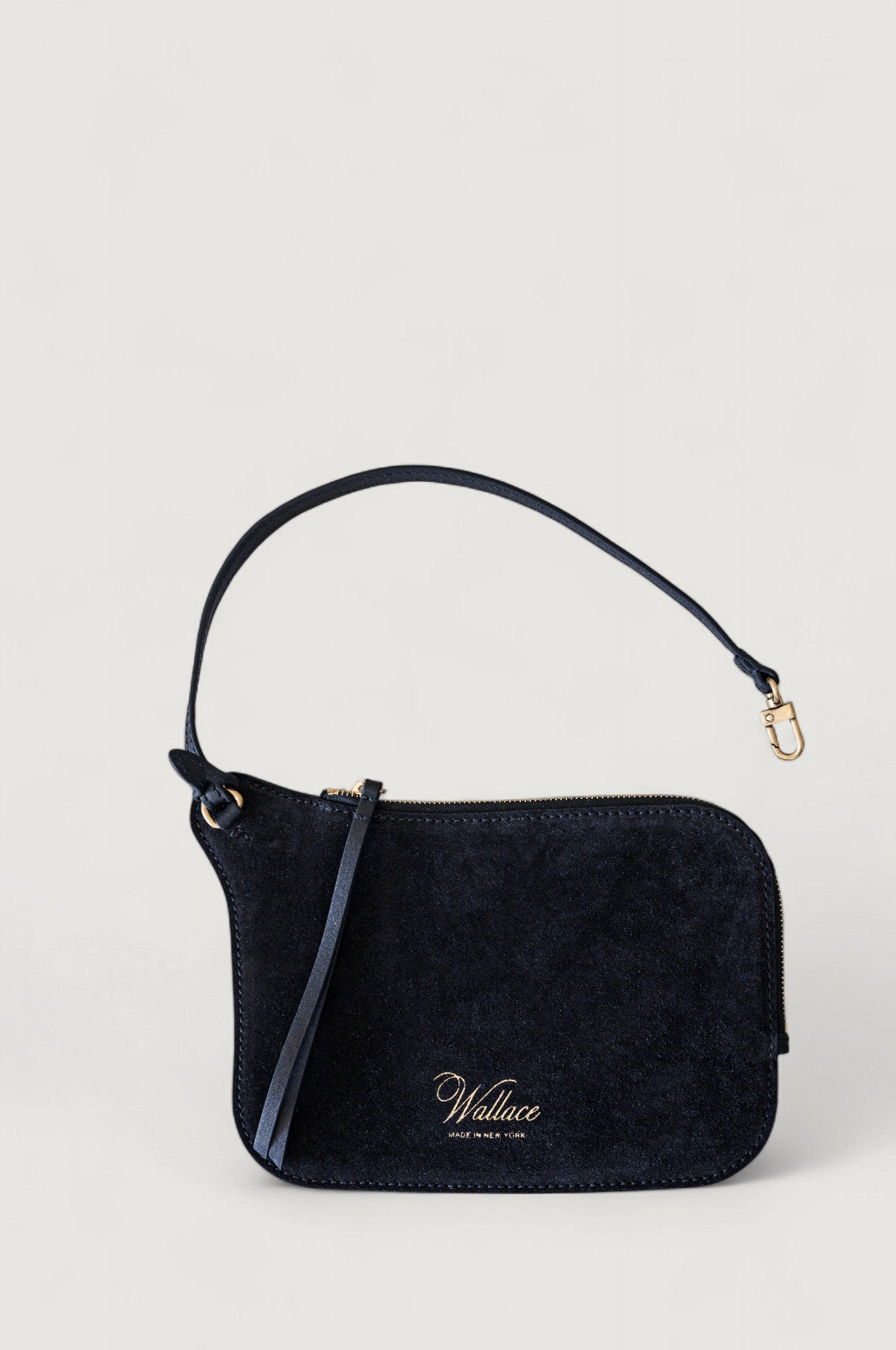 Black handbag with a visible brand logo on a light gray background