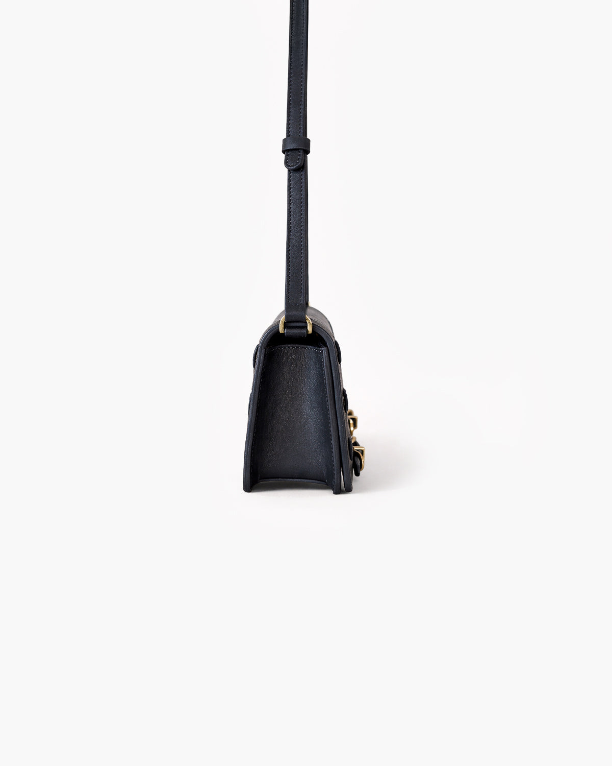 Black handbag with a strap on a white background