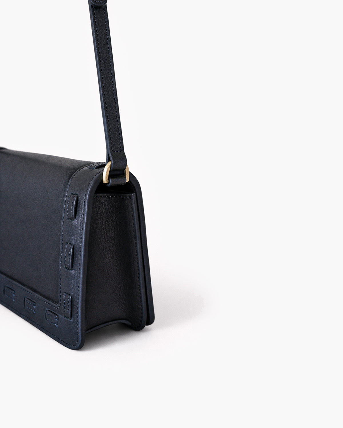 Black handbag with a strap on a white background