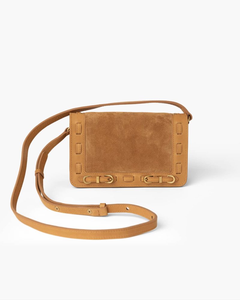 Cognac suede crossbody handbag with brass hardware on a white background