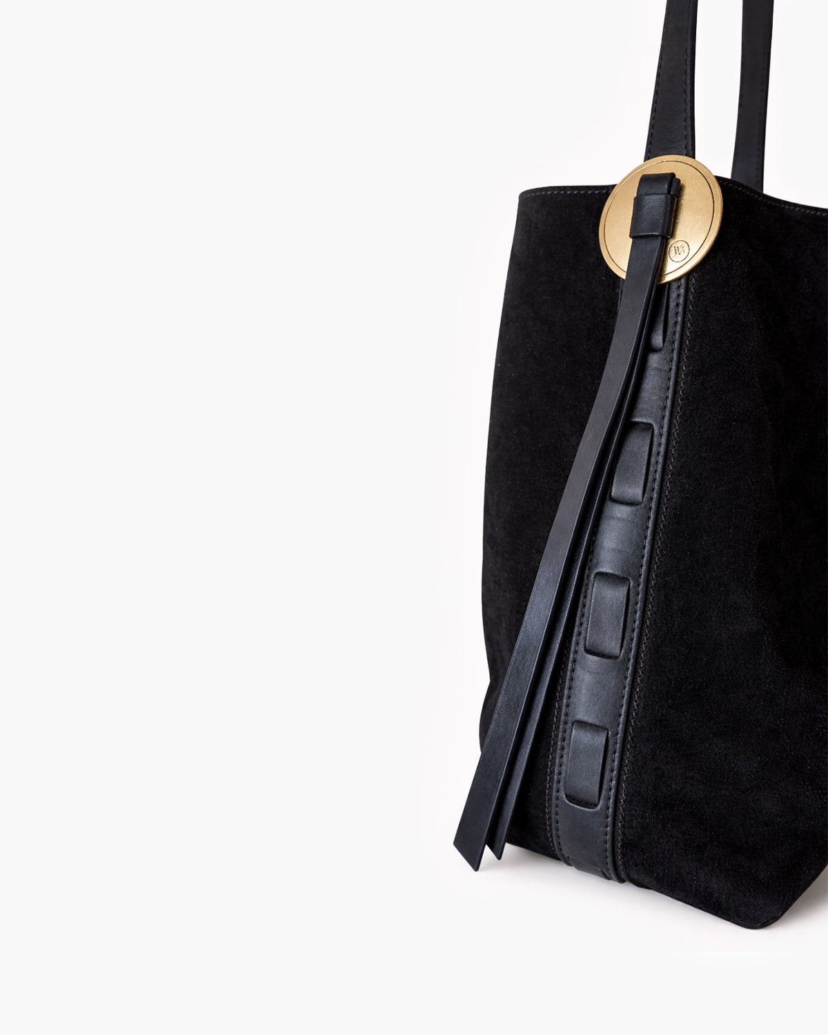 Black suede handbag with a gold buckle on a white background