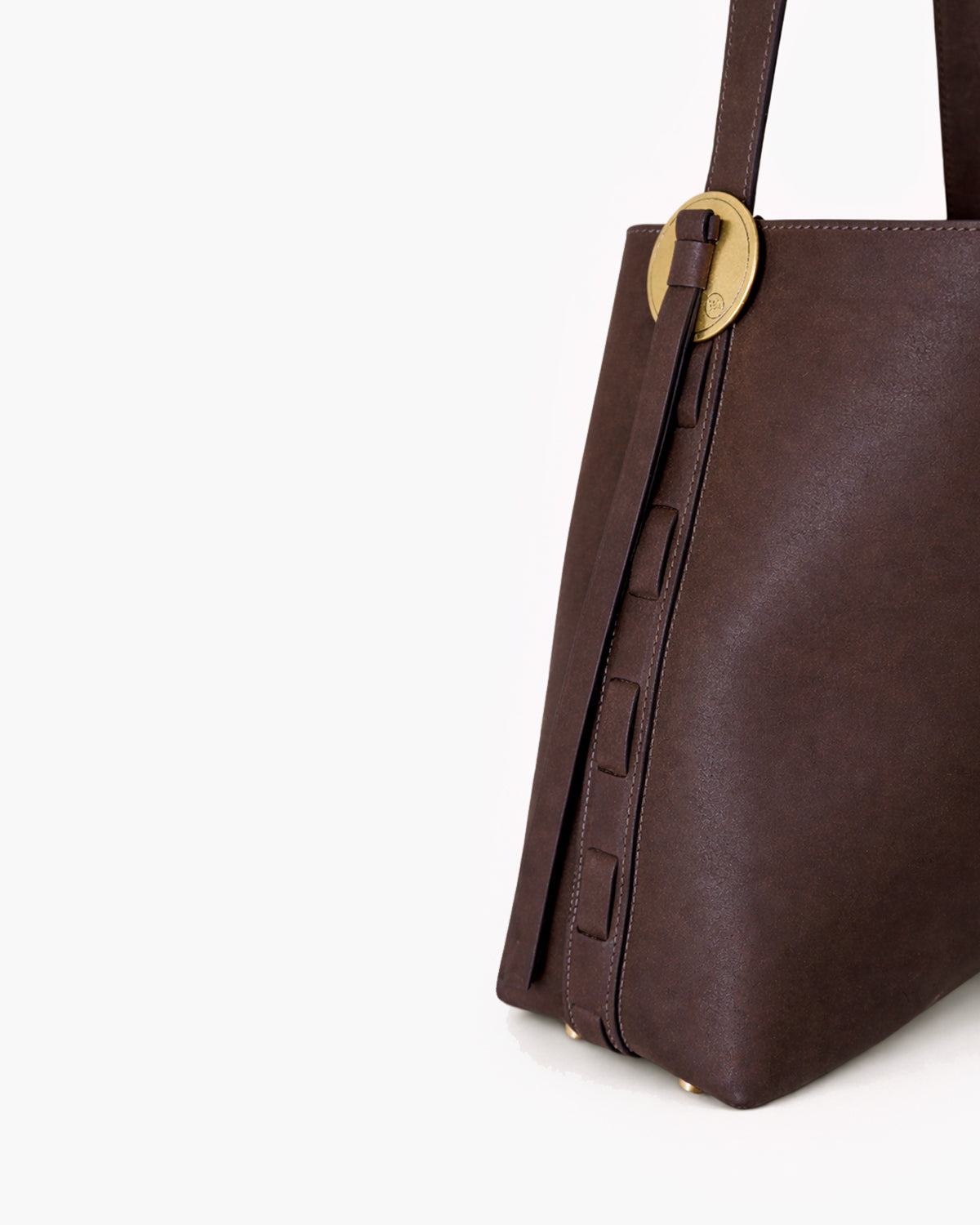 Brown leather handbag with a gold buckle on a white background