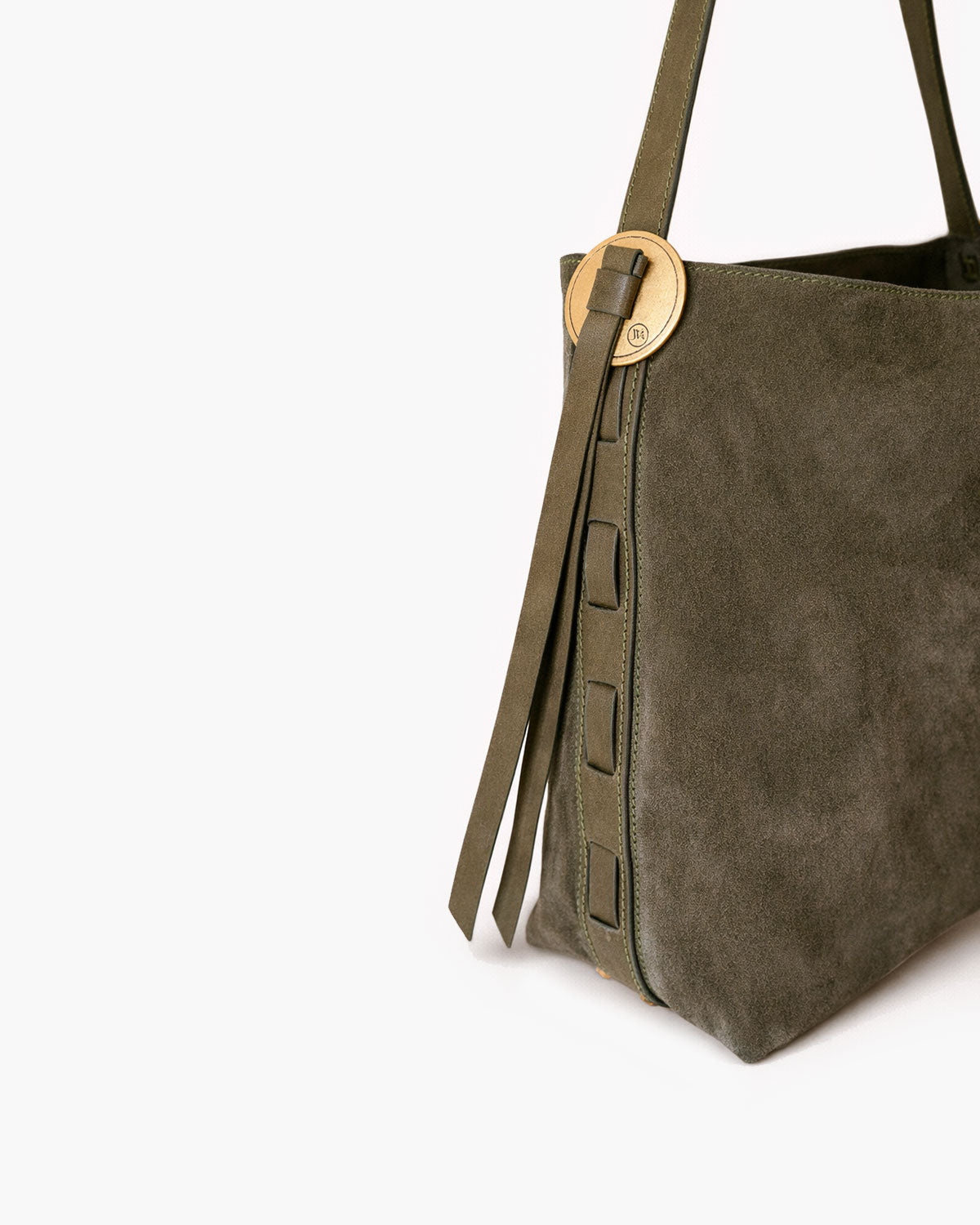 Green suede handbag with a gold clasp on a white background