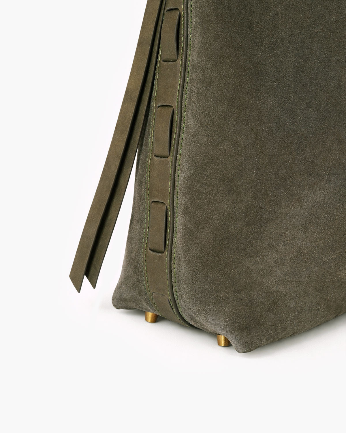 Close-up of a green suede bag with a strap on a white background
