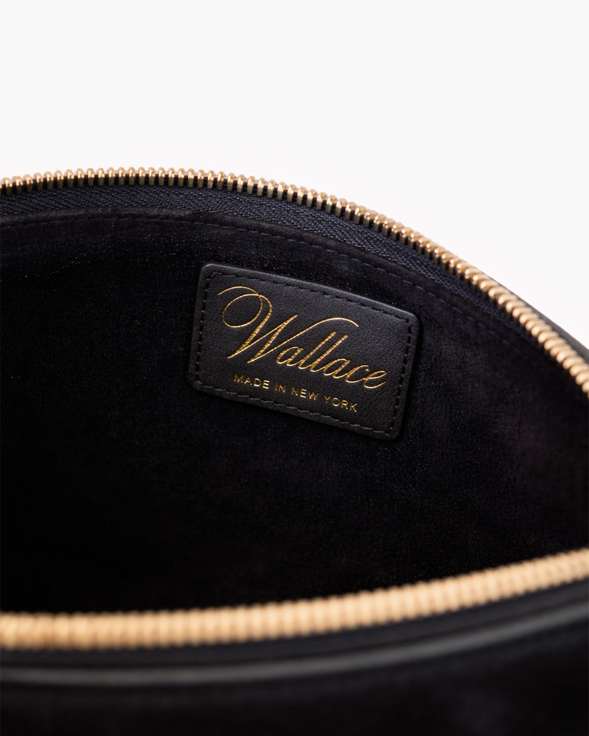 Black interior of a pouch with 'Wallace' brand label on a white background