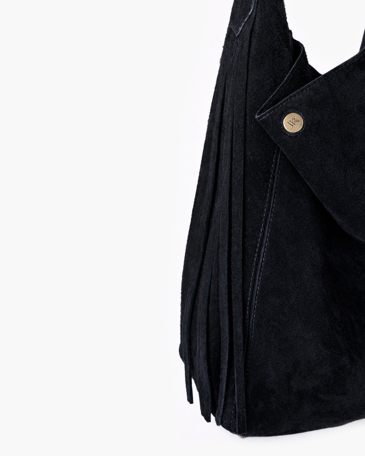 Black leather bag with a button and fringe on a white background