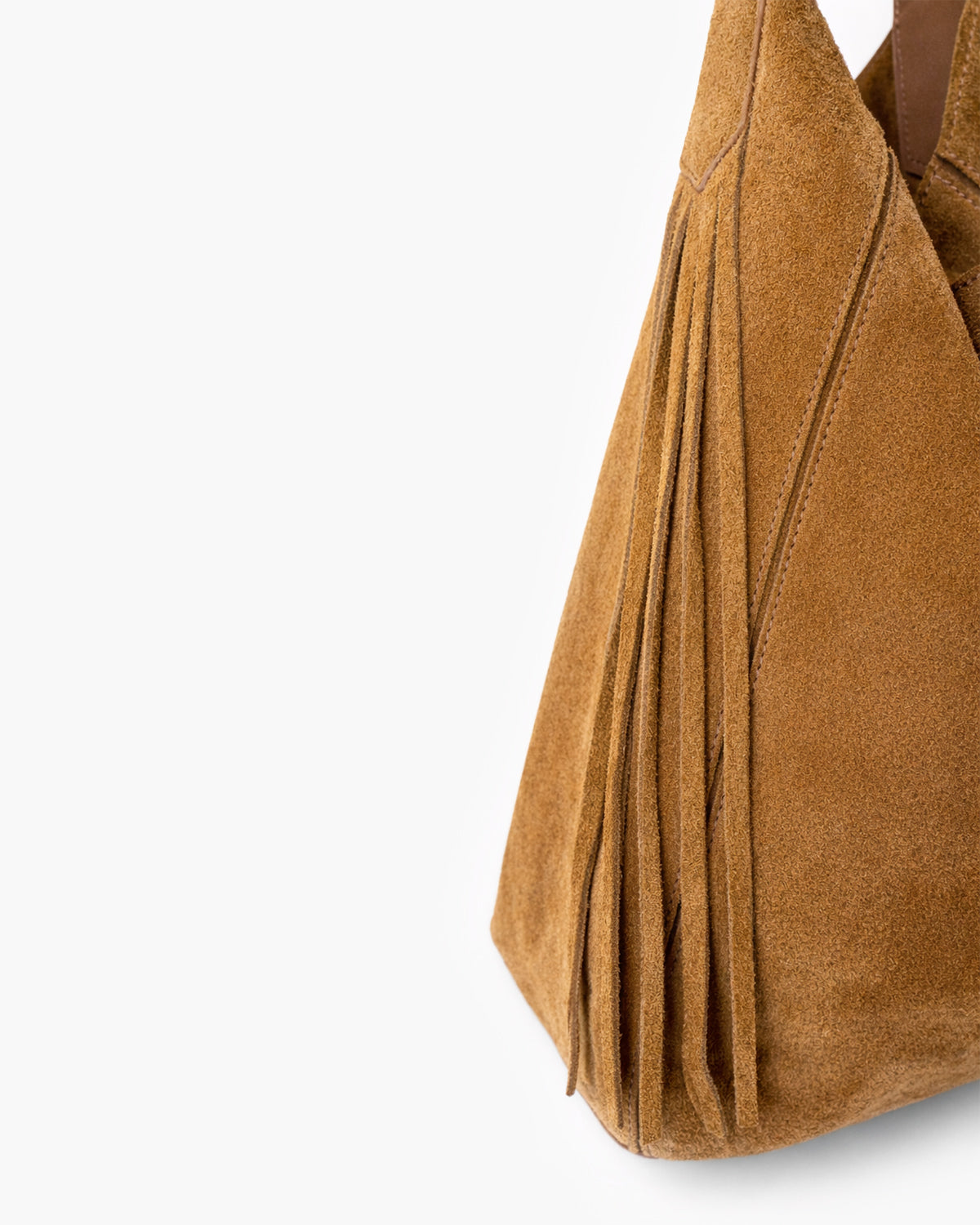Close-up of brown suede handbag with fringe on a white background