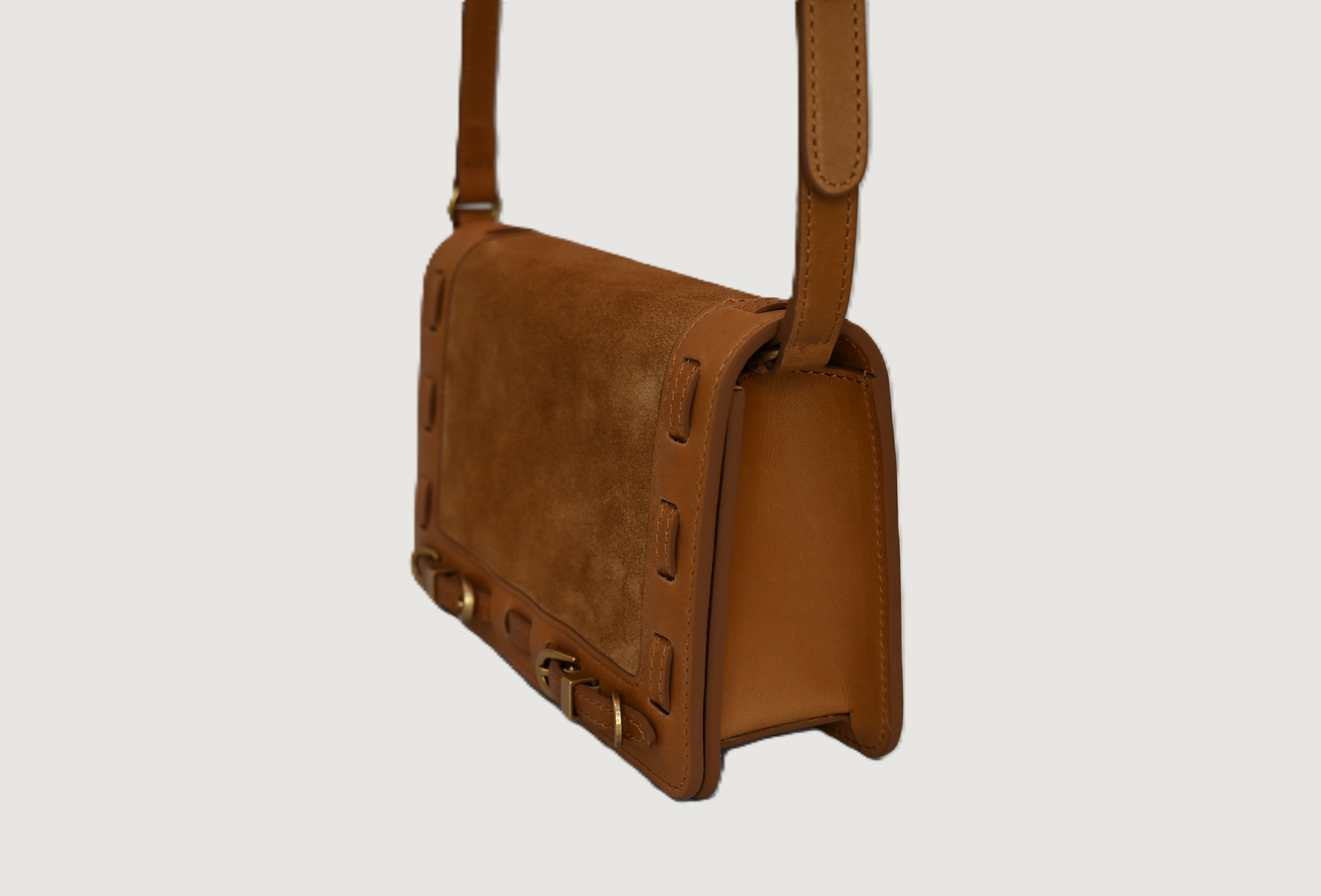 Cashew leather handbag on a light gray background