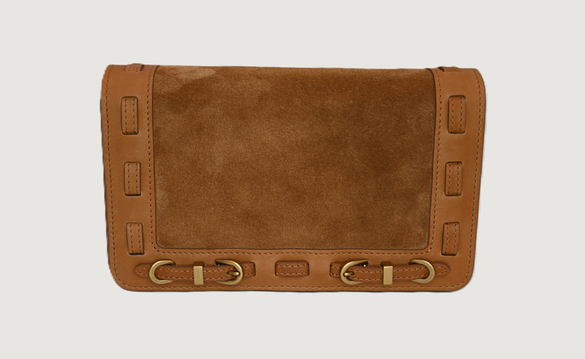 Cashew leather clutch bag with brass accents on a light gray background